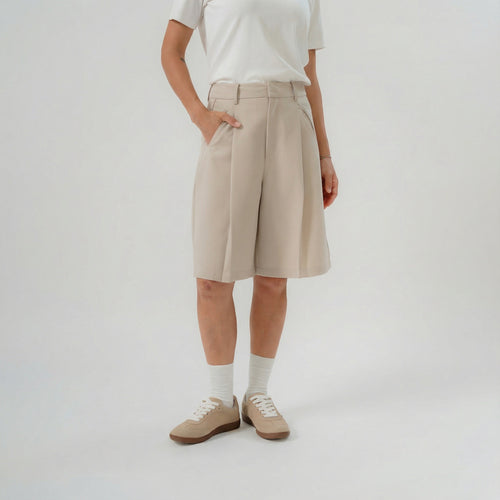 Women wearing beige bermuda pants with modern silhouette for daily wear