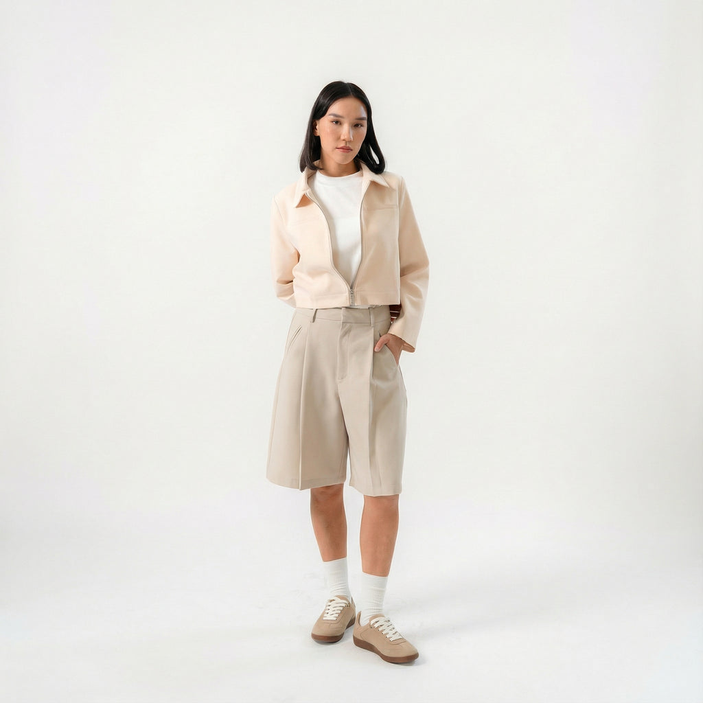 women wearing a beige biker jacket with full zip and bermuda pants with modern silhouette, design for daily city wear