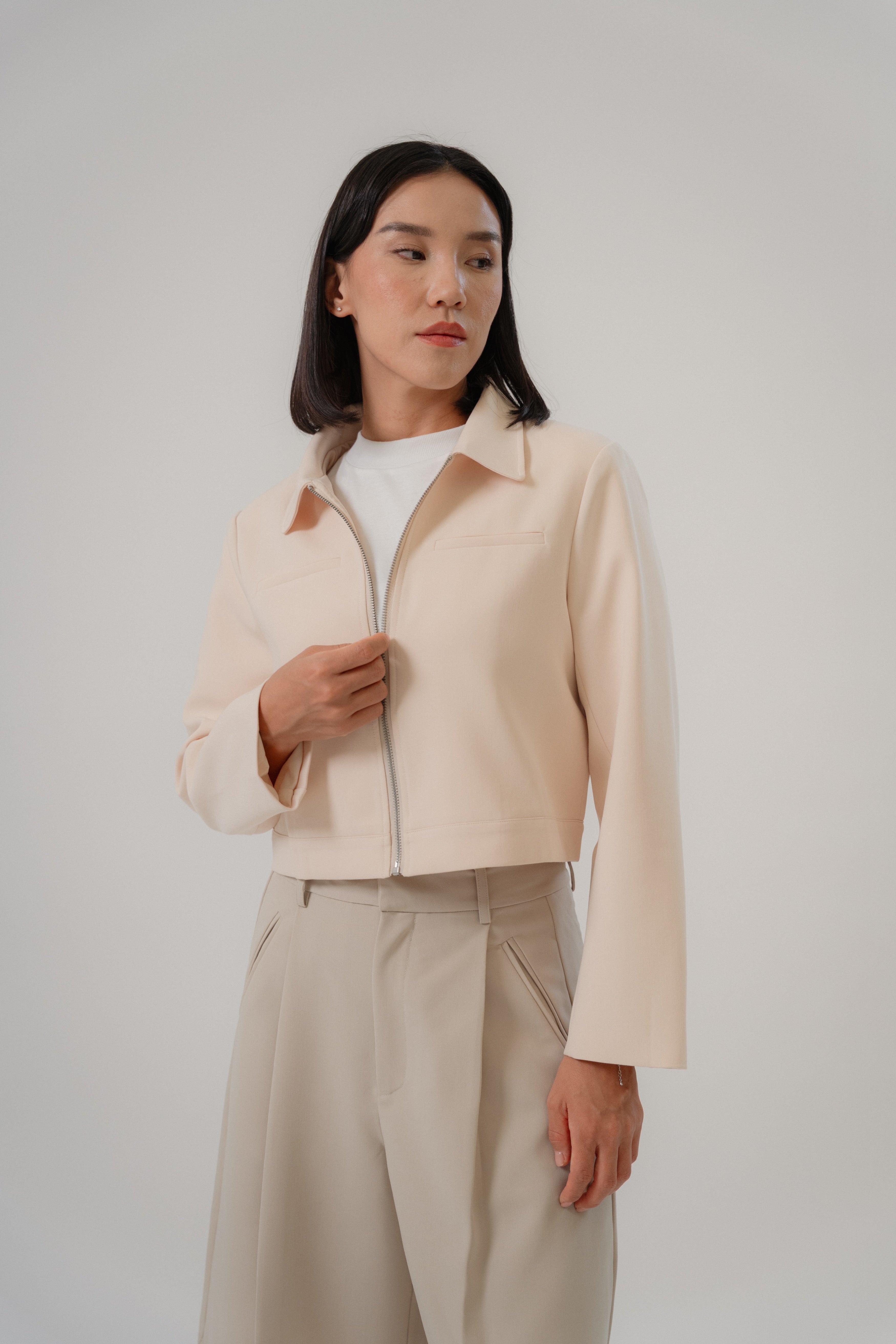 women wearing a beige biker jacket with full zip, regular fit, design for daily city wear