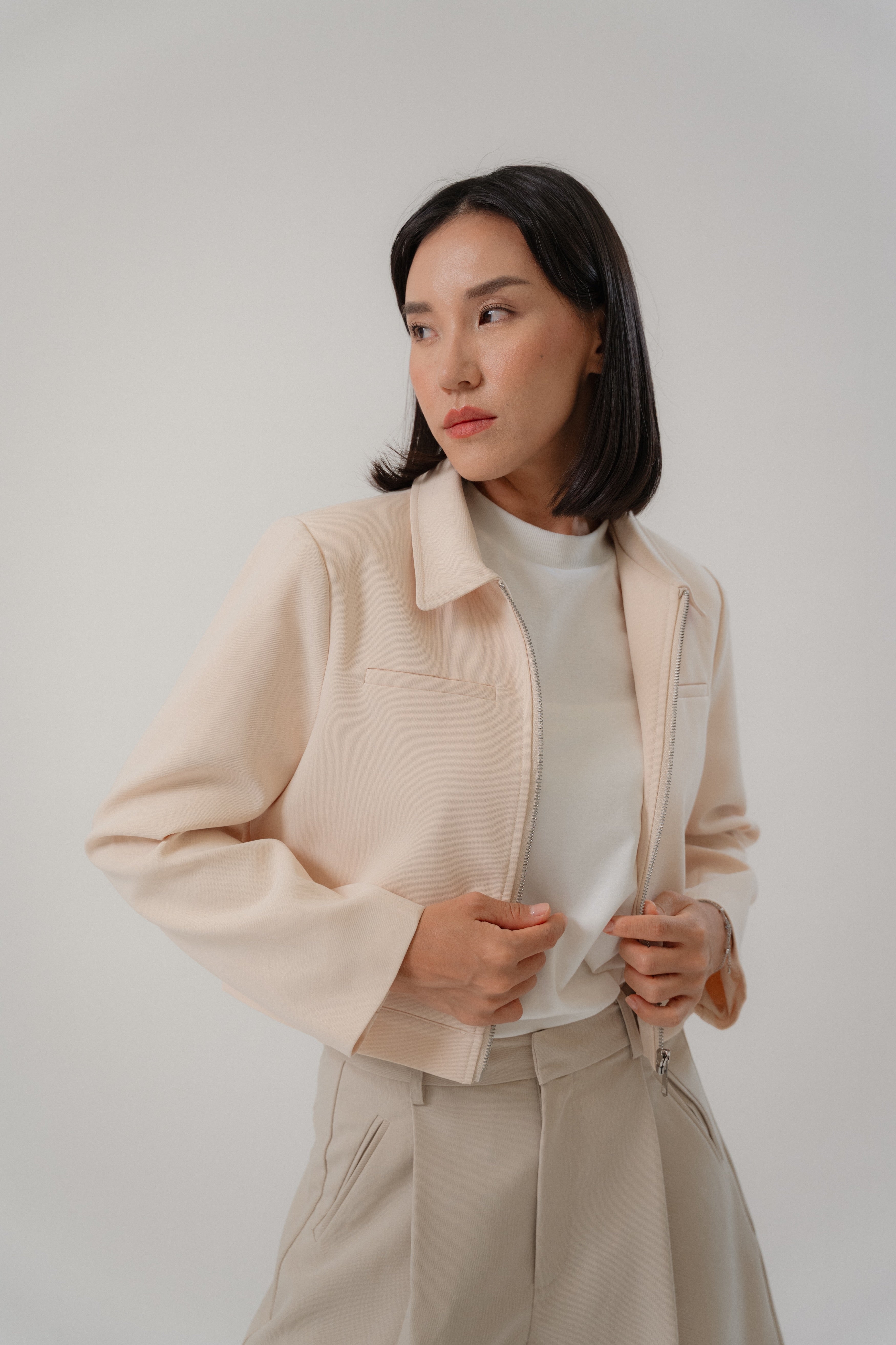 women wearing a beige biker jacket with full zip, regular fit, design for daily city wear