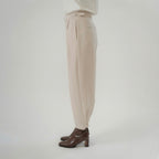 beige cross pleated pants side view with balloon silhouette and modern design