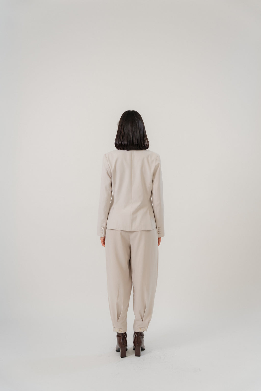 beige cross pleated pants and single breasted blazer with modern silhouette, design for office and city wear
