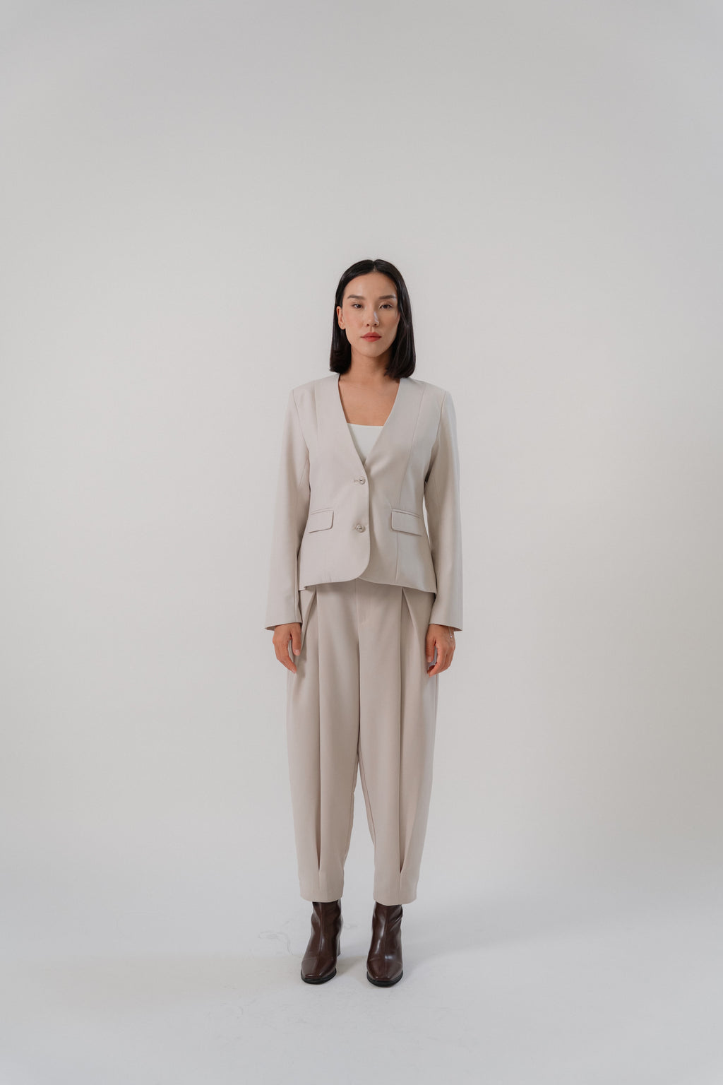 beige single breasted blazer and cross pleated pants with modern silhouette, design for office and city wear