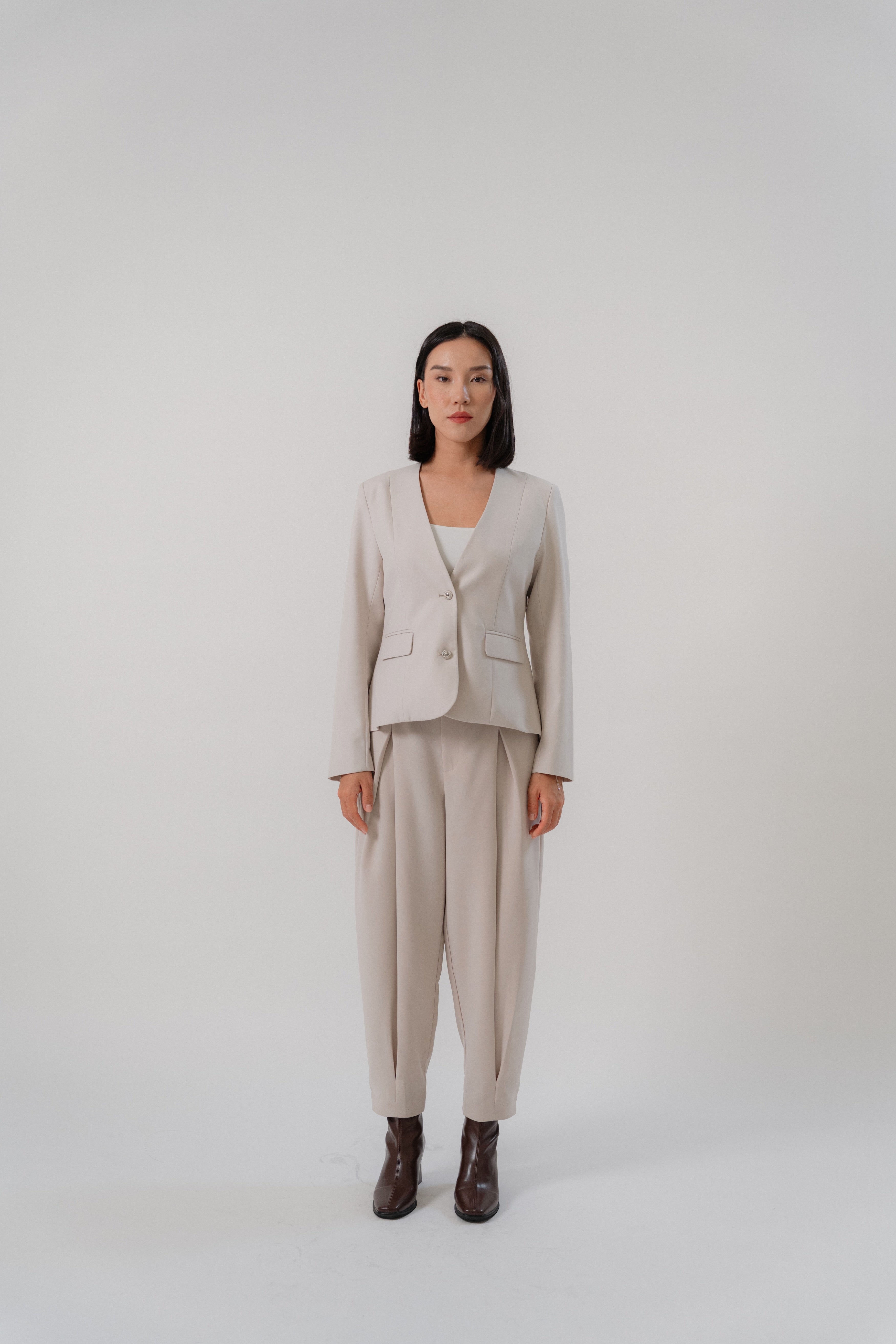 beige single breasted blazer and cross pleated pants with modern silhouette, design for office and city wear