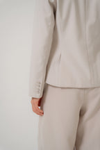 beige tailored blazer with modern silhouette and buttoned cuff, design for office and city wear
