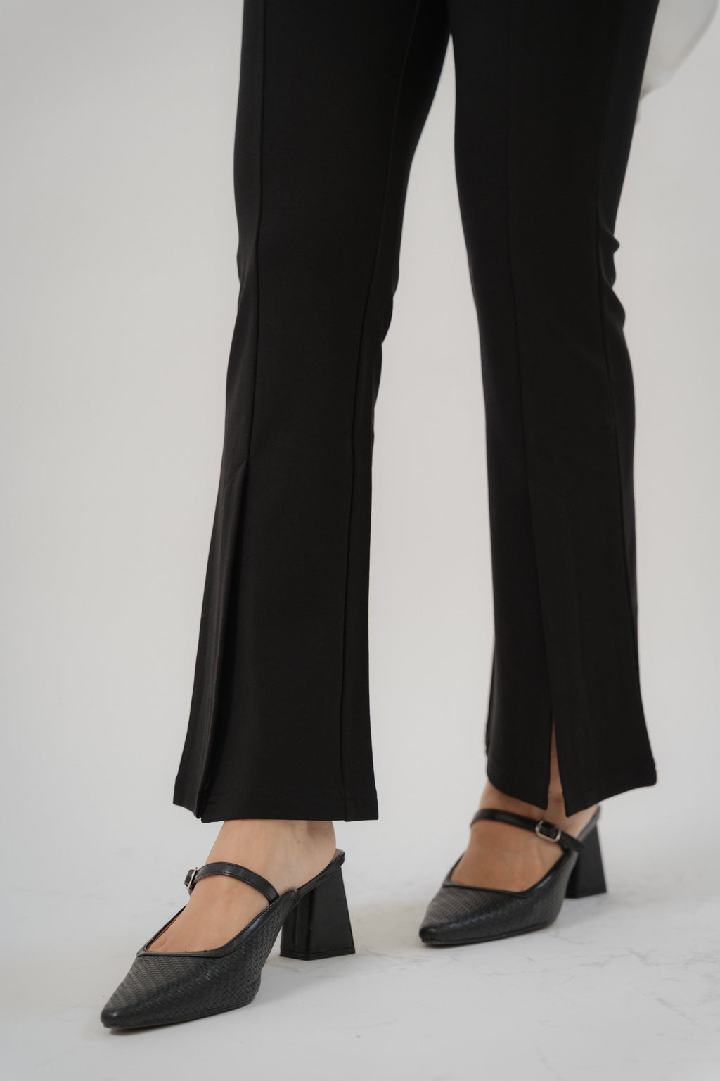 women wearing black bootcut pants with high waist silhouette, made with roman knit fabric, design for daily and office wear.