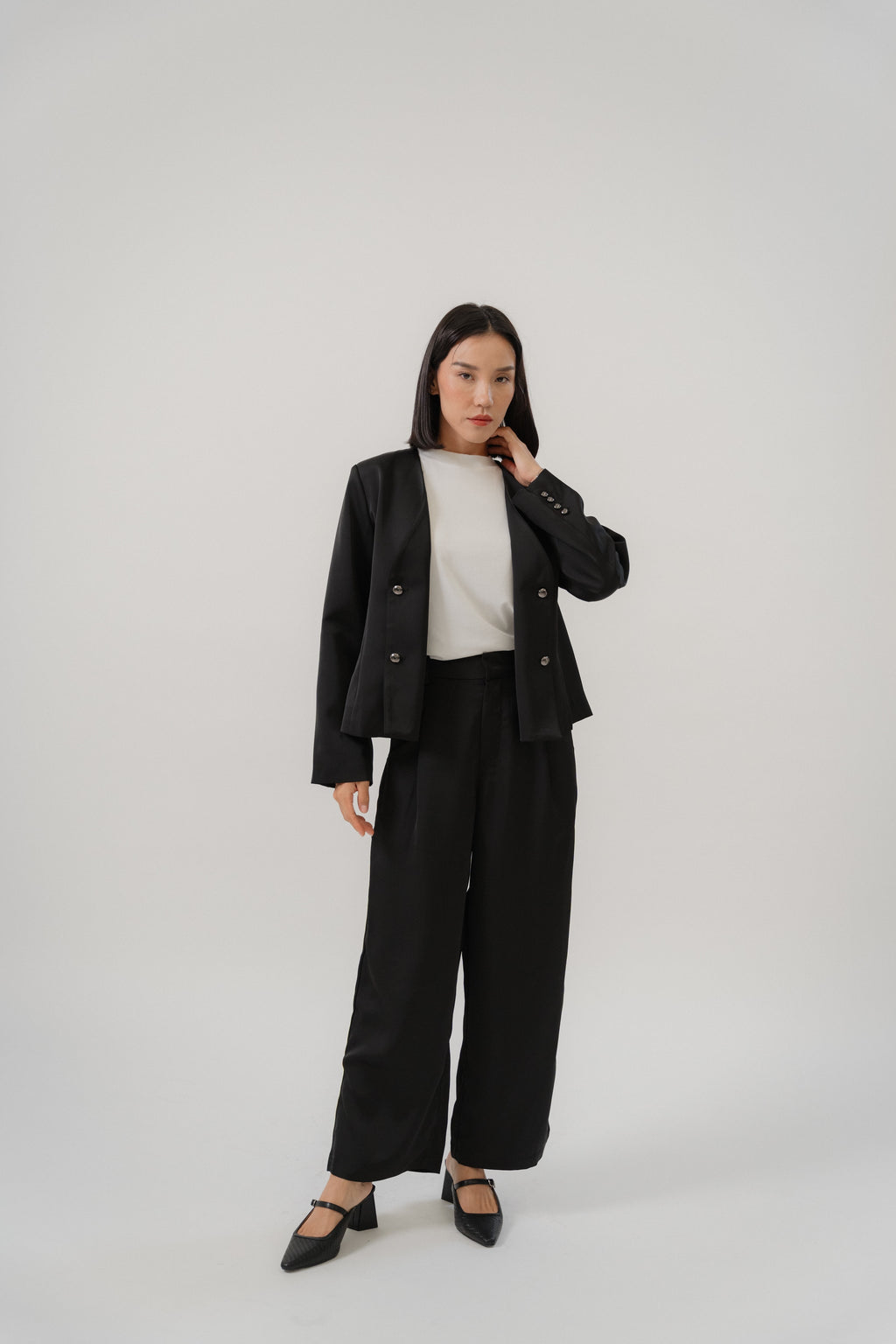 Black tailored blazer and satin pants for women with a modern silhouette, designed for office and city wear.
