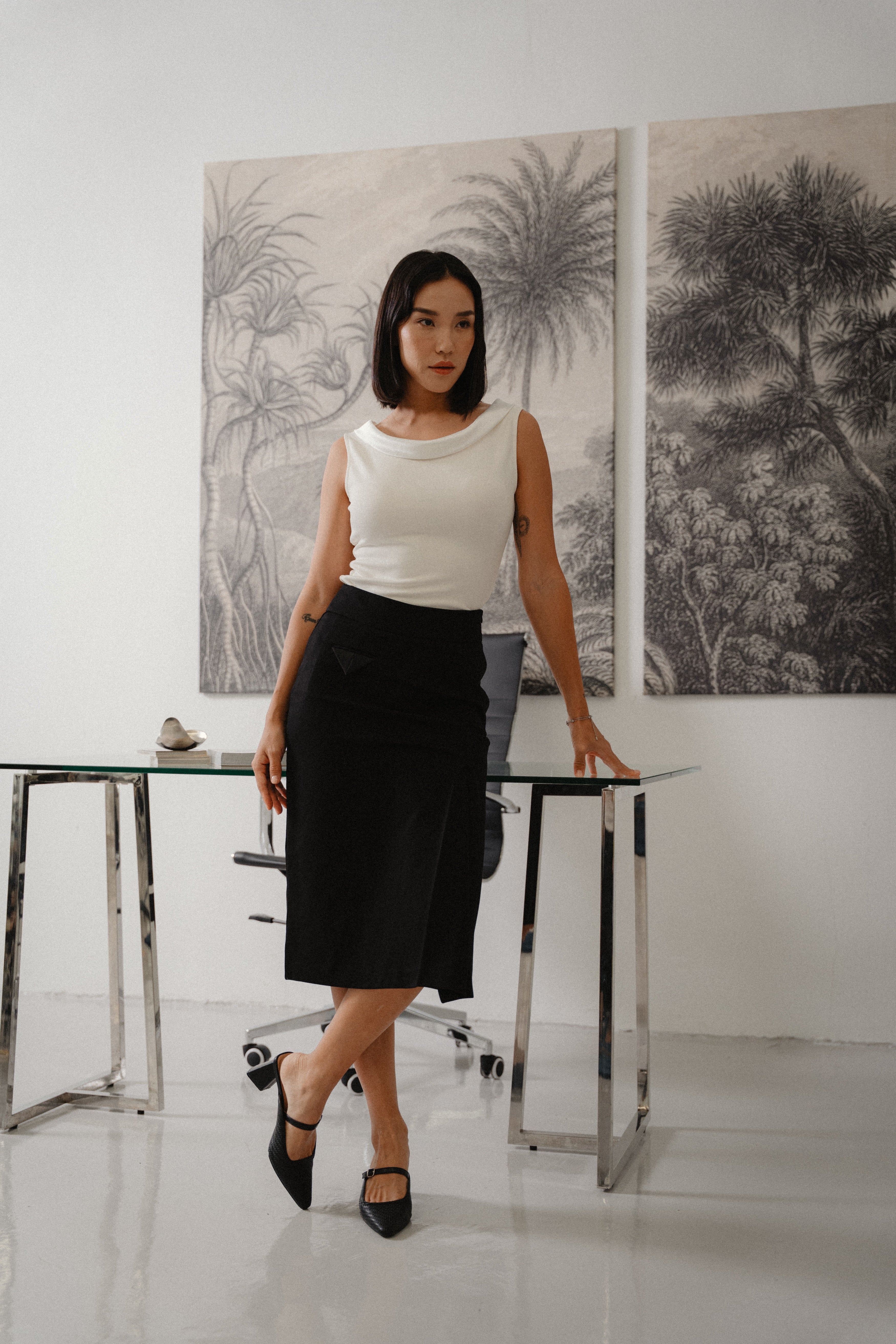black straight slim skirt with wide waistband, large pleat, pocket square details, design for office and city wear.