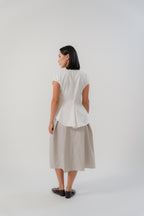 women wearing beige crossing pleated skirt and white capsleeve blouse with back flare, boat neckline, regular fit timeless design, perfect for office and daily wear