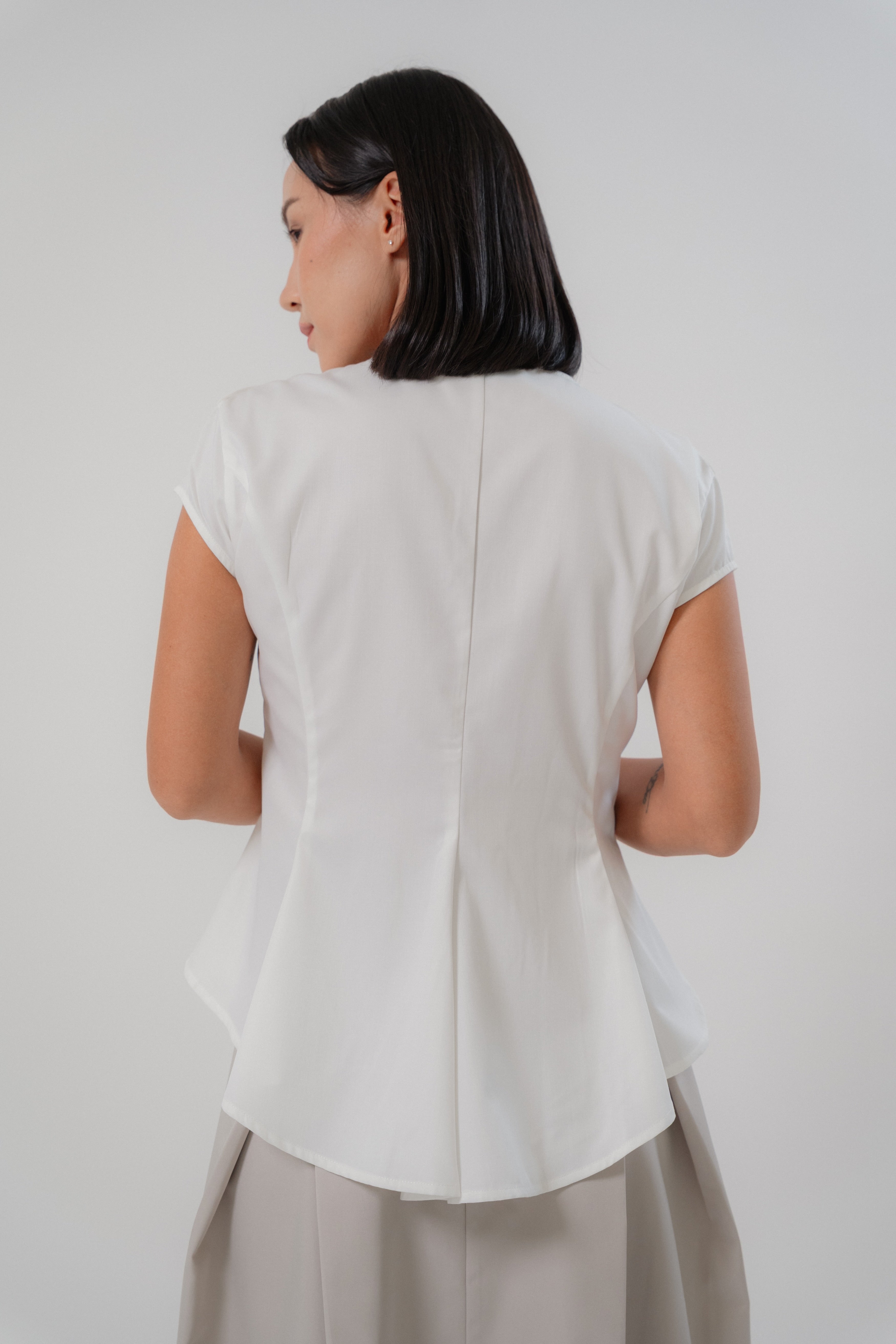 women wearing white capsleeve blouse with back flare, boat neckline, regular fit timeless design, perfect for office and daily wear