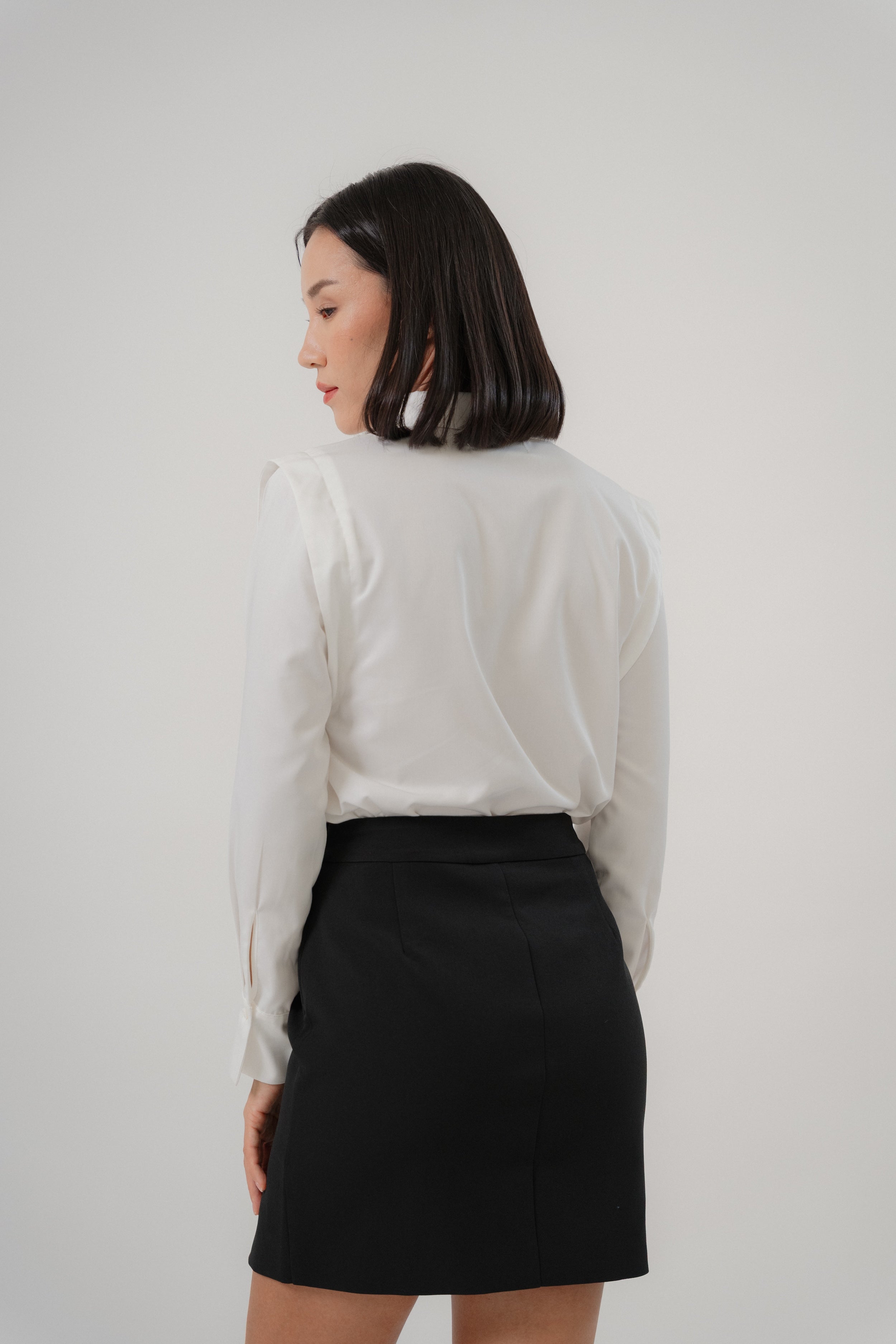 women wearing a white collared wide shoulder blouse with regular fit, design for office wear