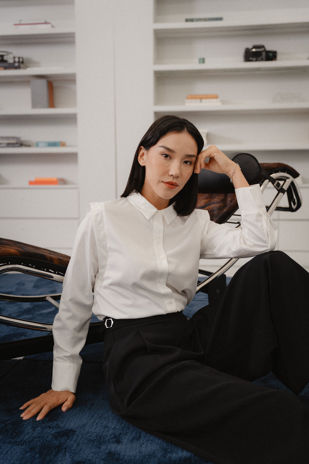 women wearing a white collared wide shoulder blouse with regular fit, design for office wear