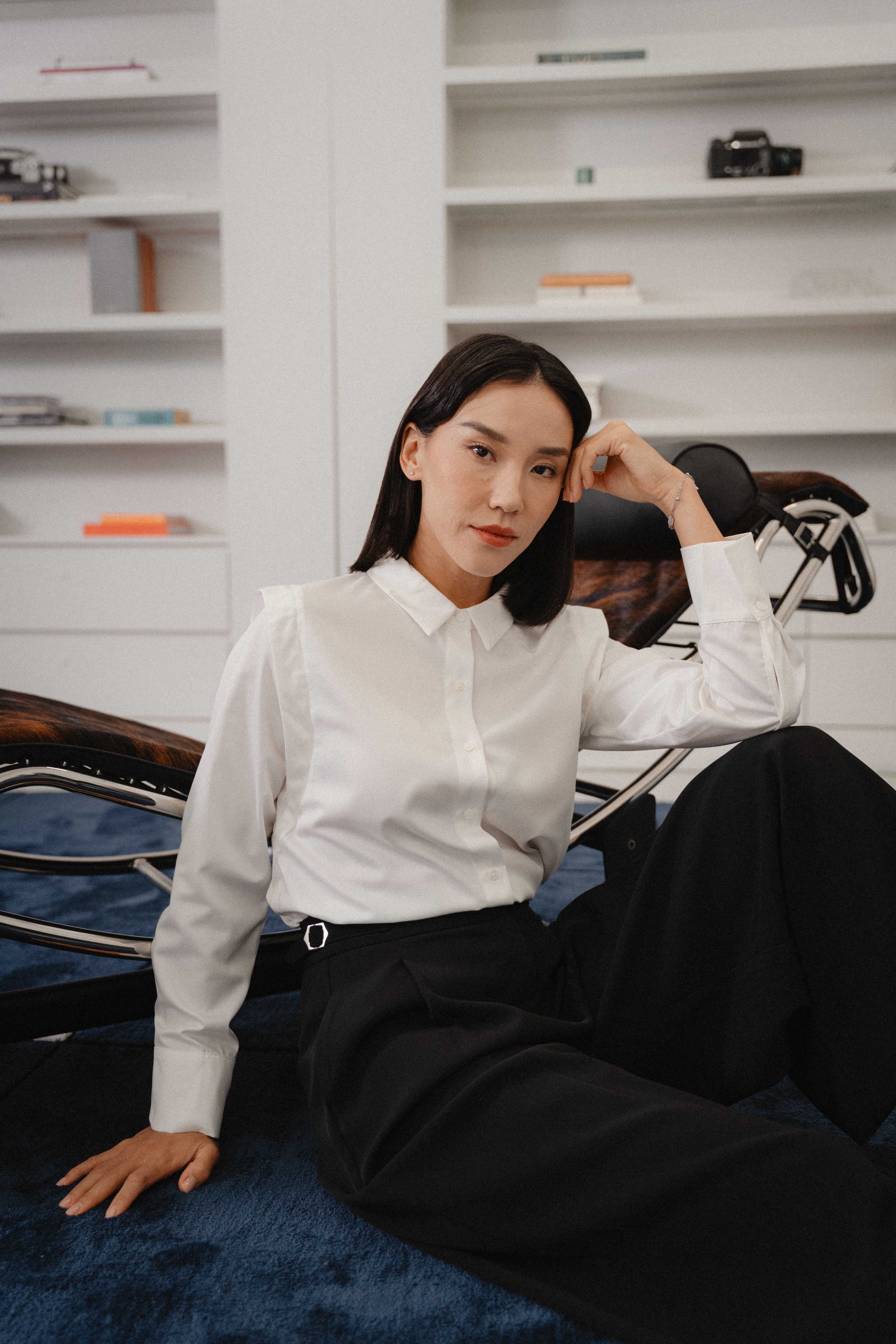 women wearing a white collared wide shoulder blouse with regular fit, design for office wear