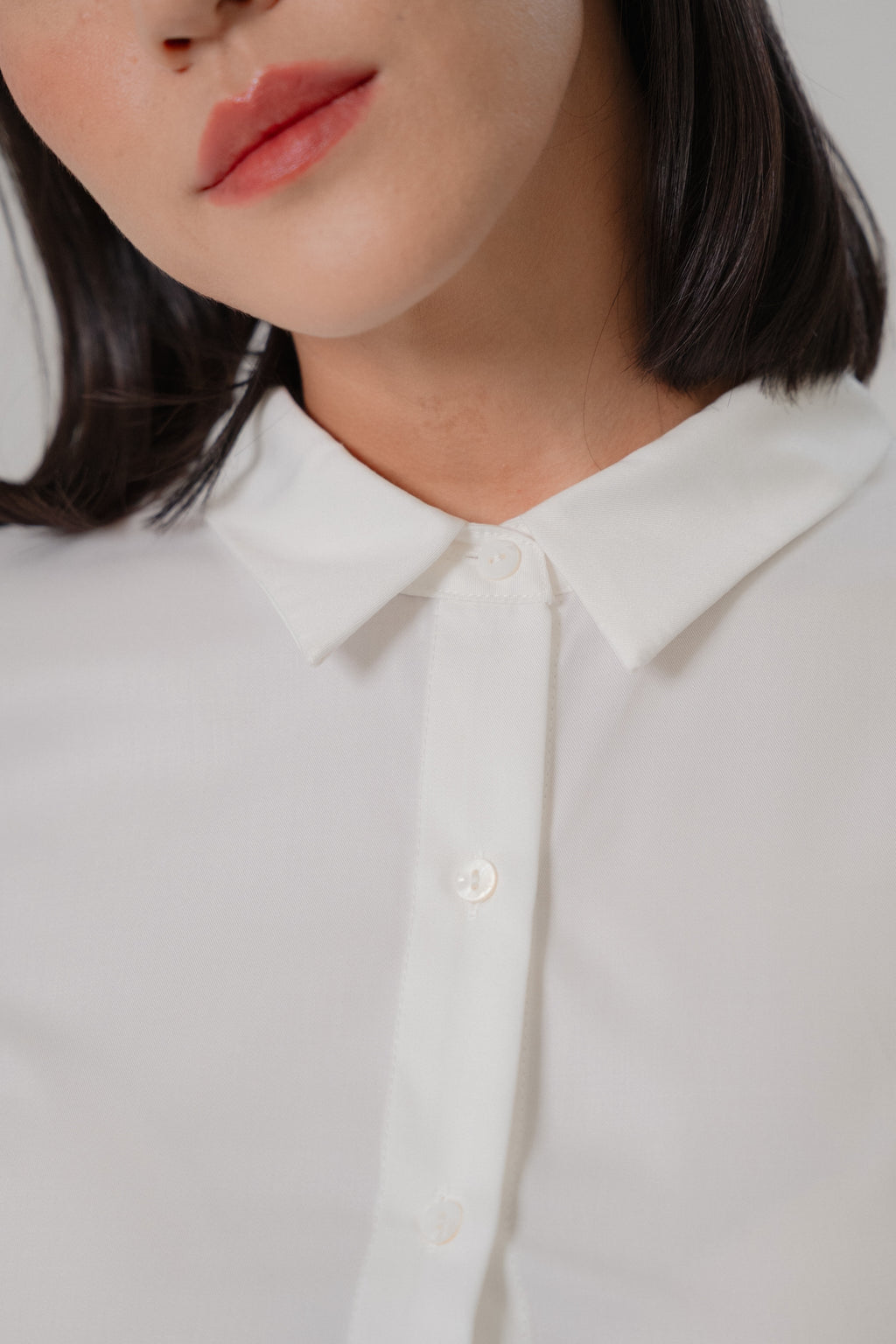 women wearing a white collared wide shoulder blouse with regular fit, design for office wear