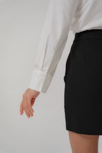 women wearing a white collared wide shoulder blouse with regular fit, design for office wear
