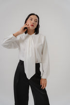 women wearing round neck collar tie blouse with classic blouse silhouette, design for office and city wear