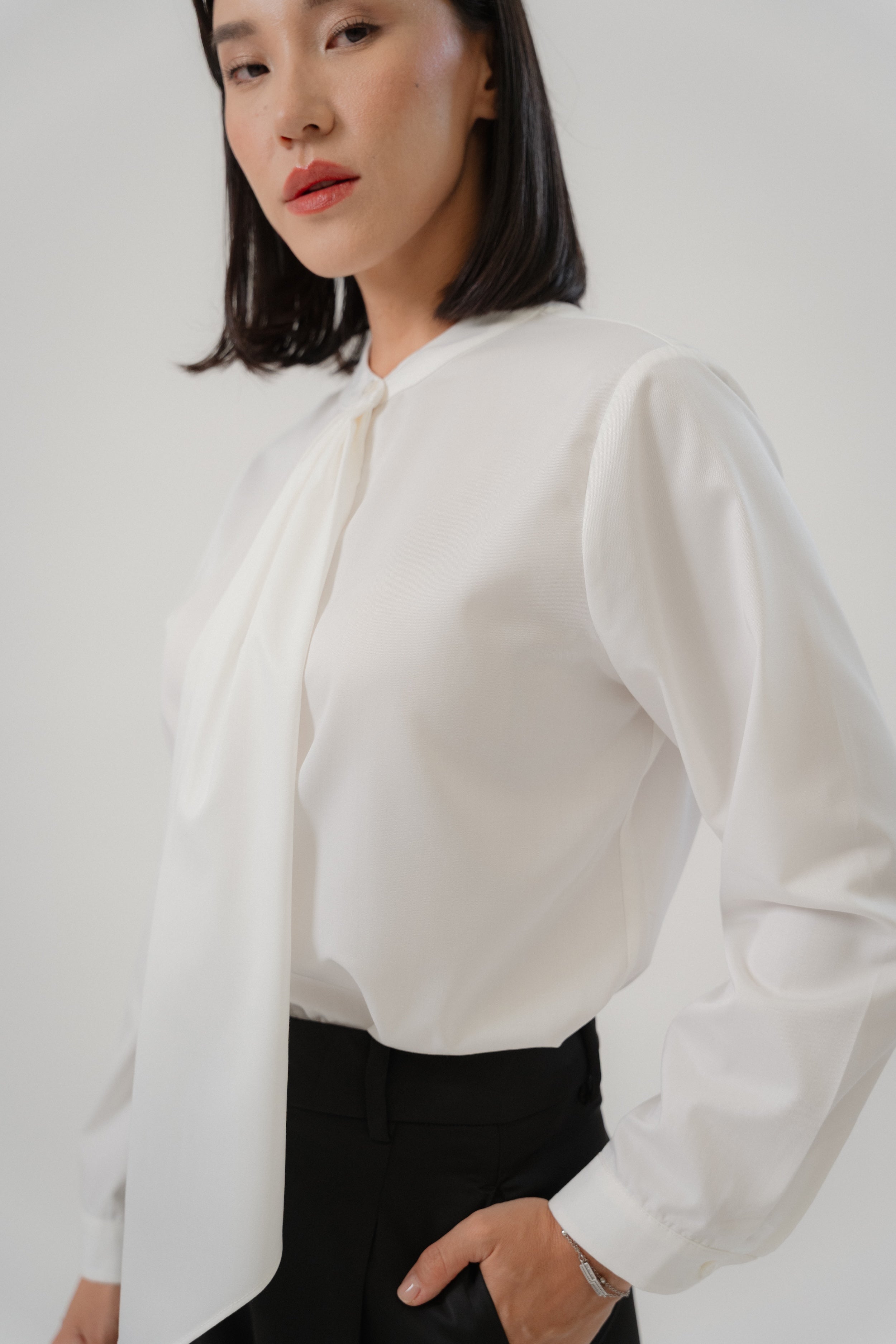women wearing round neck collar tie blouse with classic blouse silhouette, design for office and city wear