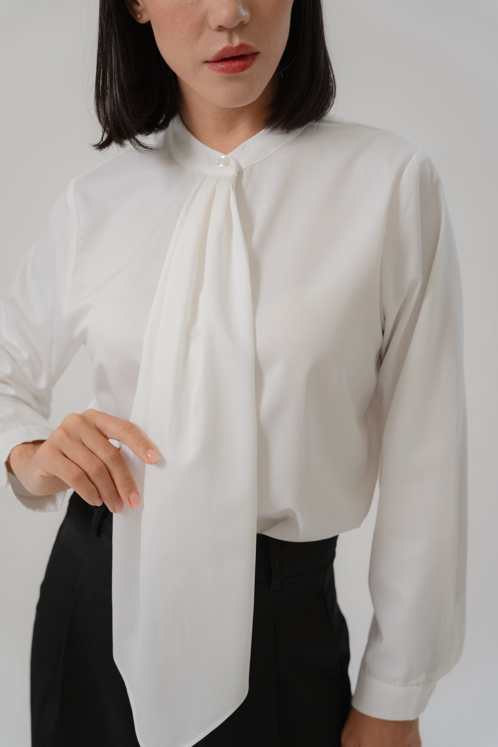 women wearing round neck collar tie blouse with classic blouse silhouette, design for office and city wear