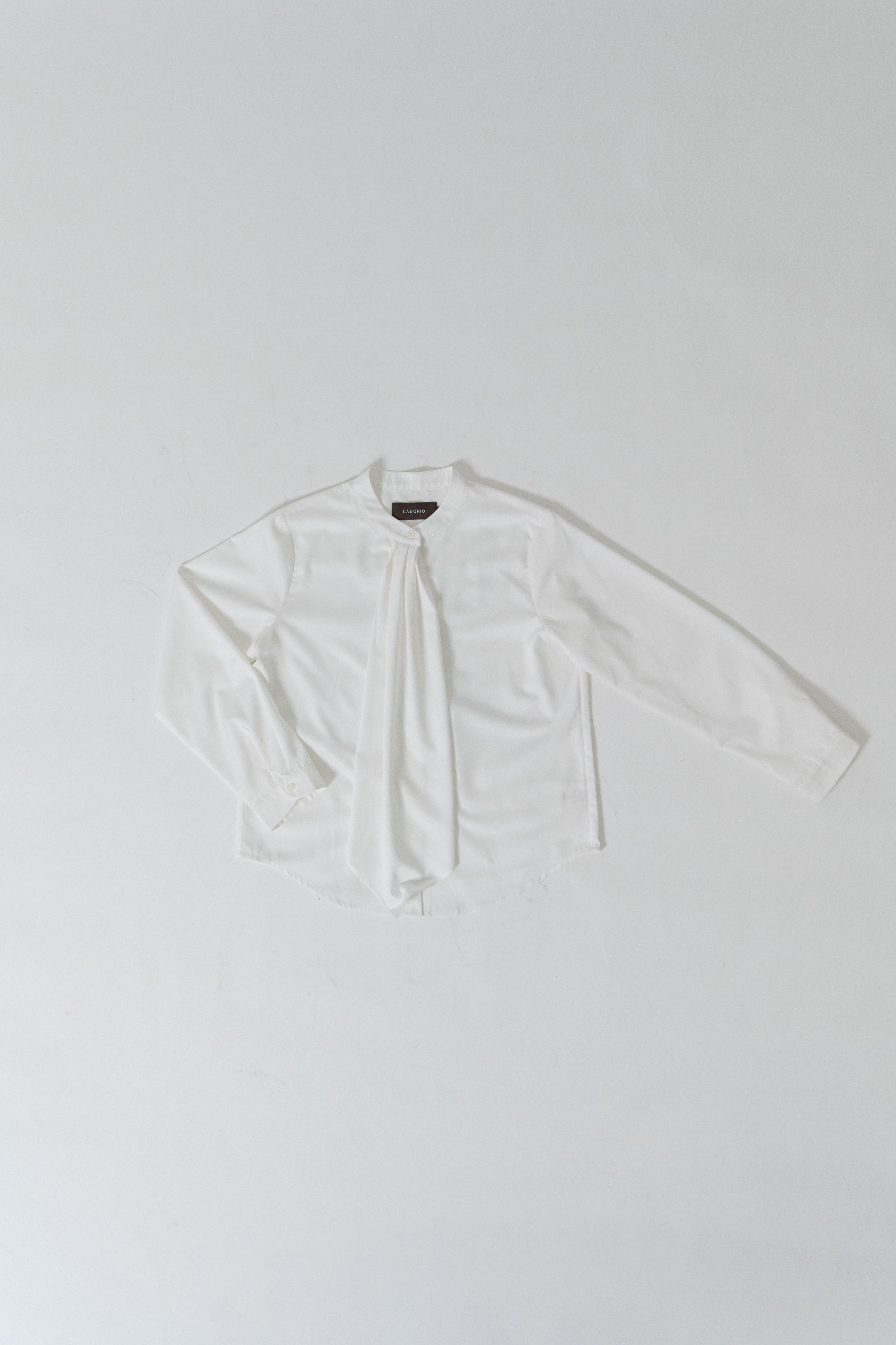 women wearing round neck collar tie blouse with classic blouse silhouette, design for office and city wear