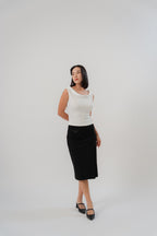 white sleeveless top with boat neckline in satin, comfortable fit, designed for women's office and city wear.