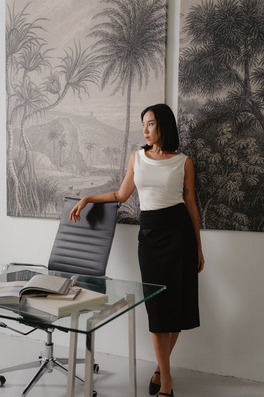 black straight slim skirt with wide waistband, large pleat, pocket square details, design for office and city wear.