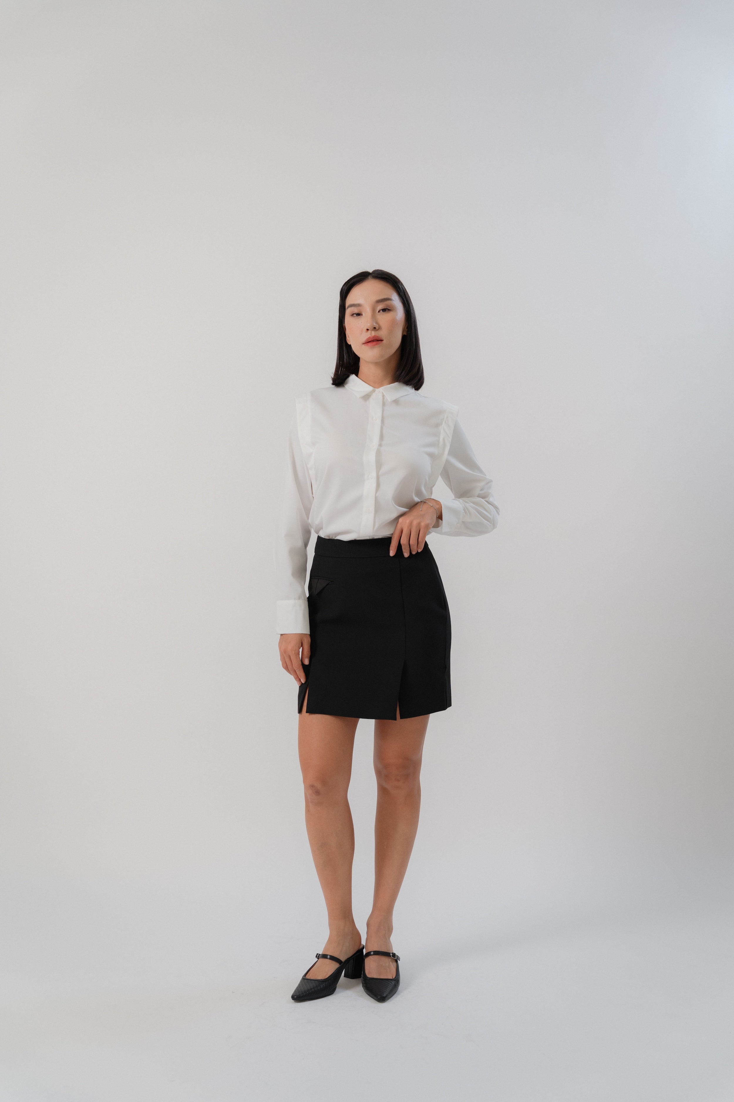 women wearing a white collared wide shoulder blouse with regular fit, design for office wear
